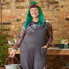 Woman wearing slate grey dungarees