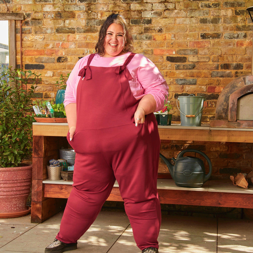 Woman wearing burgundy dungarees